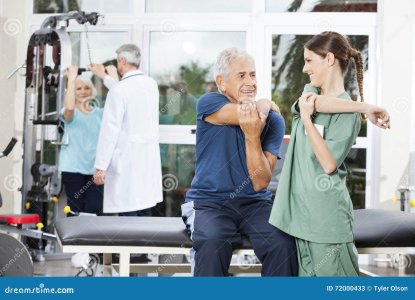 nurse-guiding-senior-patient-arm-exercise-rehab-center-smiling-female-fitness-72000433.jpg
