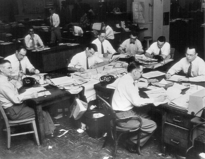 This undated file photo shows men in the newsroom of the The Kansas City Star on 18th Street and Grand Avenue in Kansas City, Mo. On Sunday, Dec. 20, 2020, the newspaper's top editor apologized for past decades of racially biased coverage and has posted a series of stories examining how it ignored the concerns and achievements of Black residents and helped keep Kansas City segregated.