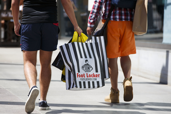 customers-walk-with-foot-locker-inc-shopping-bags-on-the-third-street-picture-id591788102