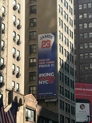 An ad advocating for LeBron James to sign with the Knicks this summer hangs near Madison Square Garden.