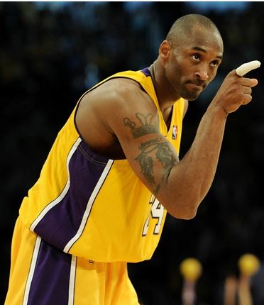 Kobe+Bryant+points+a+taped+index+finger+acknowledging+a+teammate.JPG