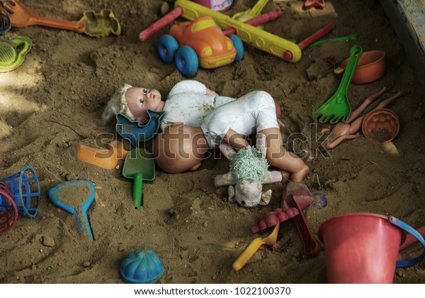 abandoned-old-childrens-toys-sand-600w-1022100370.jpg