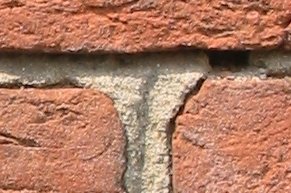 Three_old_bricks_held_together_with_mortar.jpg