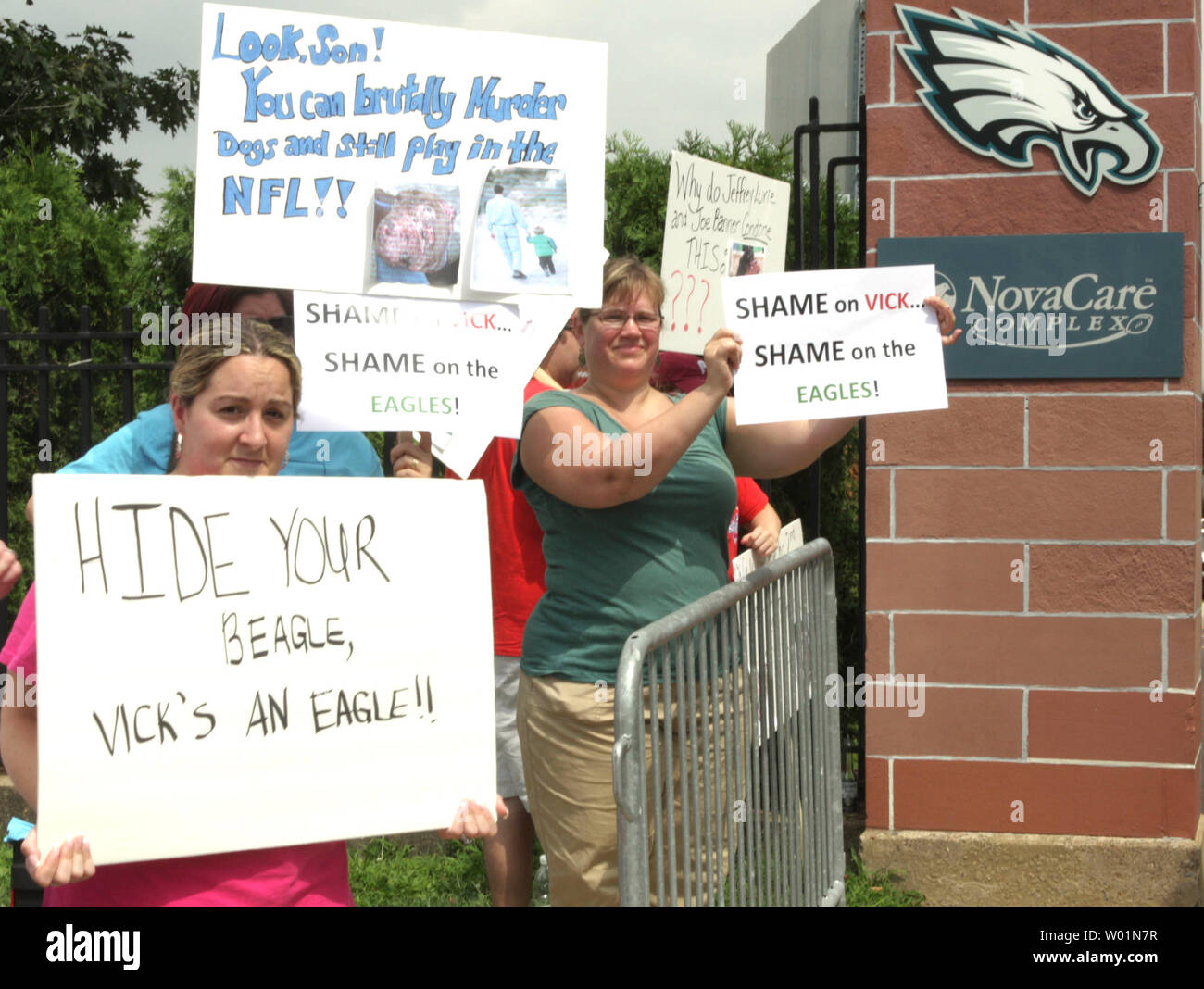 protestors-hold-up-signs-at-the-front-gate-to-the-philadelphia-eagles-novacare-center-friday-august-14-2009-during-a-news-conference-inside-announcing-the-signing-of-quarterback-michael-vick-for-a-16-million-contract-with-the-team-vick-was-the-no1-draft-pick-in-2001-by-the-atlanta-falcons-and-once-the-highest-paid-player-in-football-but-was-convicted-of-running-a-dog-fighting-operation-and-has-just-recently-released-from-federal-prison-upijohn-anderson-W01N7R.jpg