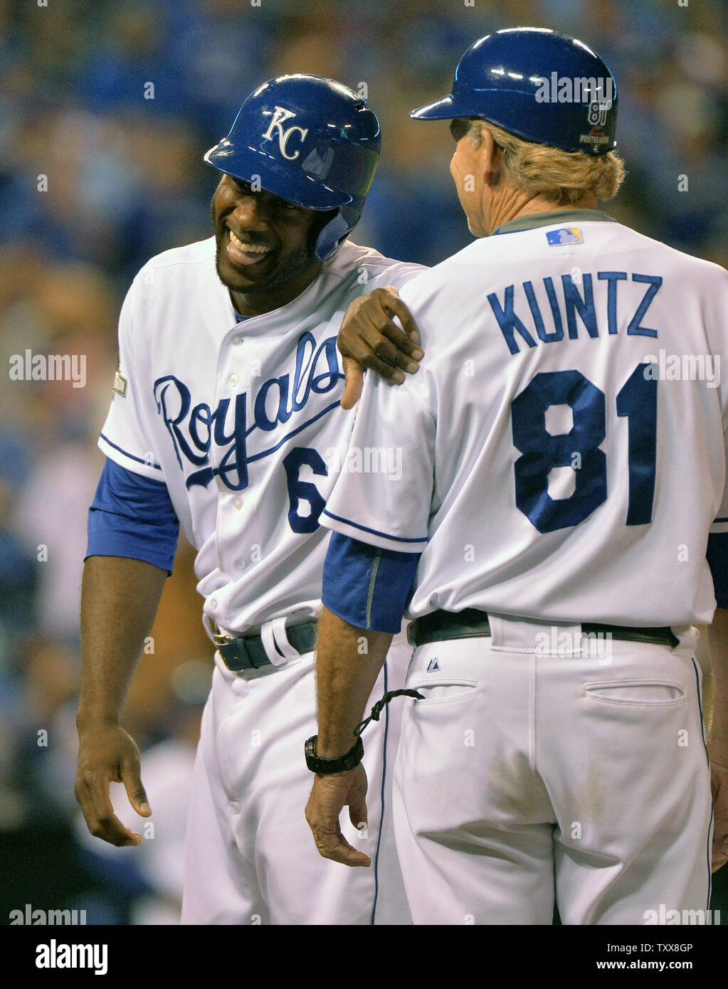 kansas-city-royals-center-fielder-lorenzo-cain-6-smiles-alongside-first-base-coach-rusty-kuntz-after-beating-out-an-infield-single-during-the-third-inning-against-the-toronto-blue-jays-in-the-alcs-game-6-at-kaufman-stadium-in-kansas-city-on-october-23-2015-kansas-city-hold-a-3-2-series-lead-photo-by-kevin-dietschupi-TXX8GP.jpg