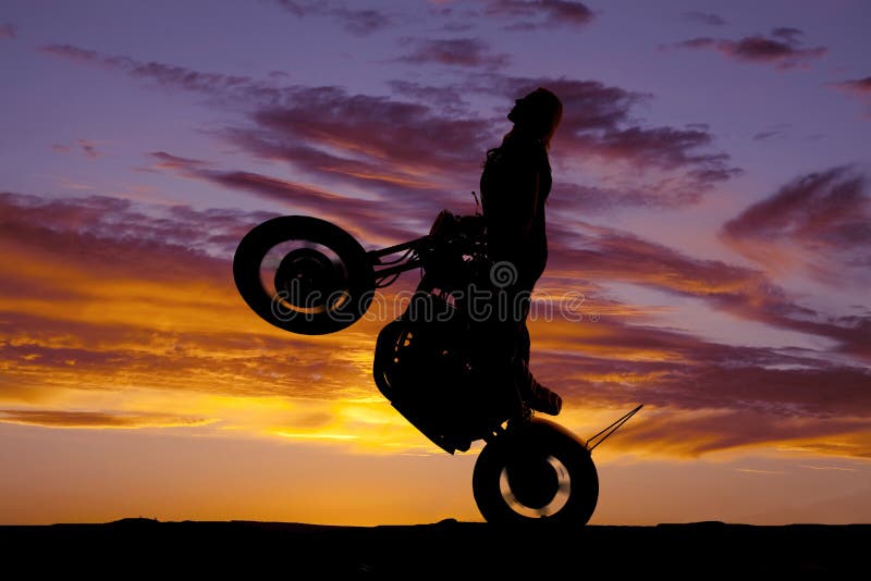 silhouette-woman-motorcycle-ride-wheelie-37062357.jpg
